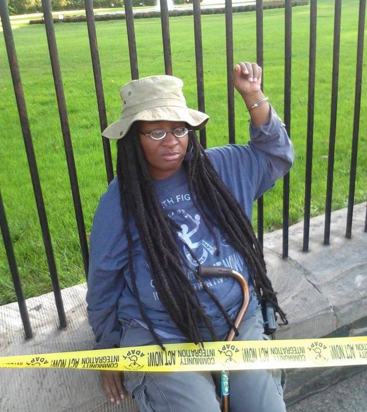 Anita Cameron  protesting with ADAPT  and her 119th arrest, she is handcuffed to the White House fence
